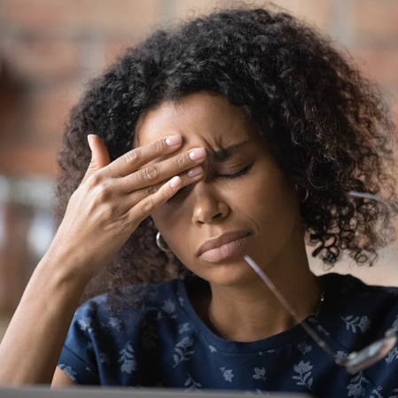 Woman With Head Pain Rubbing Her Brow